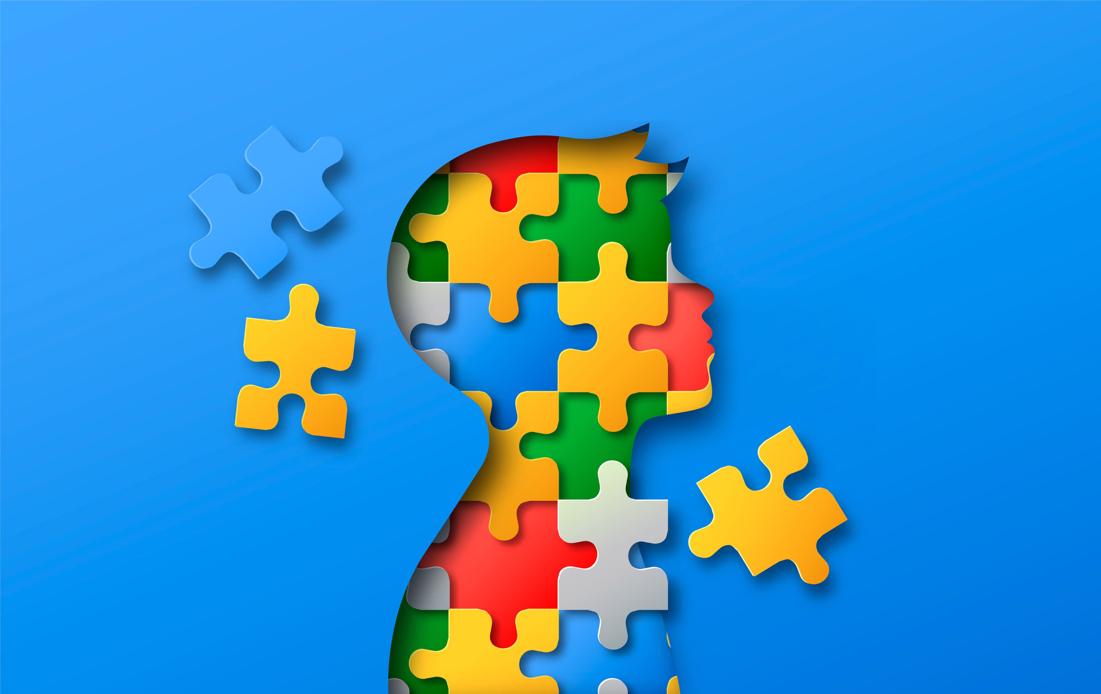Colorful puzzle pieces forming a head silhouette